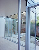 Glass doors and walls separate living space from garden