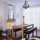 Dining room with wooden table, bench and vintage slide car