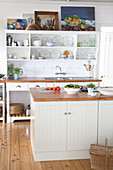 Country-style kitchen with open shelves and crockery collection