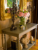 Classic console with bouquet of peonies and decorative elements