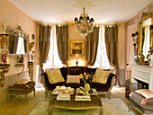 Antique living room with fireplace and chandelier