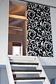 Staircase and black sliding door with white ornaments