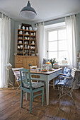 Country-style dining room with wooden furniture and blue and white textiles