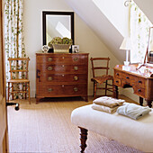 Antique wooden furniture and floral curtains in the traditional bedroom