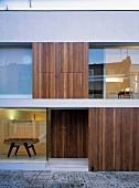View into cubist house with wood and glass facade