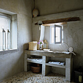 Rustic-style bathroom with concrete washbasin and small window