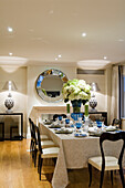 Festively laid dining table with blue and white decorations and hydrangeas