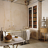 Vintage bathroom with free-standing bathtub and bookcase