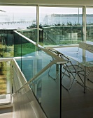 Dining table & chairs on gallery with glass balustrade