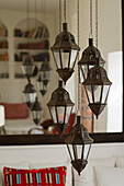 Moroccan hanging lanterns in front of a large mirror in the living room