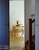 Front door and open doorway with view of dining table