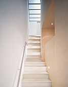Narrow stairwell with bottom view of upper flight of stairs