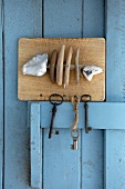 Hand-crafted key holder with fish motif made from driftwood and limestone pebbles