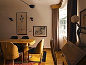 Dining room with antique bureau and black and white picture on walls