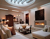 Mix of styles with contemporary furnishings, modern and antique collectors’ items and modern skylight