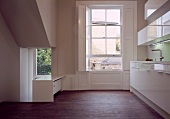 Open-plan, minimalist designer kitchen in classic setting
