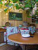 Wood-panelled room with vine plant, wooden table, vintage decoration and painting