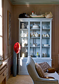 Light blue display cabinet with crockery and maritime decorations