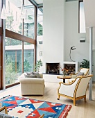 Retro armchair and couch in front of open fireplace in contemporary house