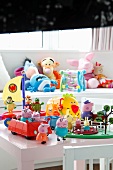 Various colourful toys on table & sofa