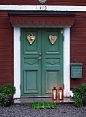 Front door (painted green) decorated with hearts