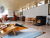 Assorted seating in a mix of styles and fireplace in a spacious living room