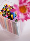 Colourful felt-tipped pens in plastic container