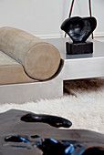 Modern, steel couch with leather cushions on soft, flokati rug