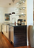 Free-standing kitchen island in front of pillar with glass shelves