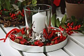 Silver tray with Christmas decorations and storm lantern