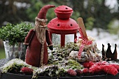 Decorative Father Christmas figure in moss with bird food and berries