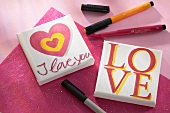 Small, home made pictures the word 'love' written on them