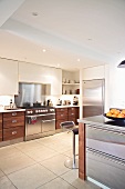 Contemporary kitchen with wood and stainless steel doors and light tiled floor