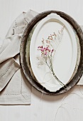Flowering twig on oval plate