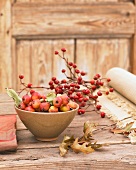 Autumn centrepiece with crab apples and rosehips on twigs