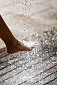 Foot in running water