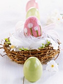 Felt Easter egg in Easter nest of feathers & twigs