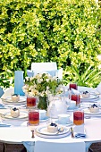 A festively laid table in a garden for brunch