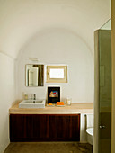 Minimalist bathroom with barrel vault ceiling - simple washstand against wall below small window