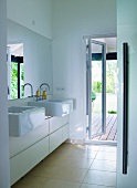 Designer bathroom with double washstand counter and open terrace door