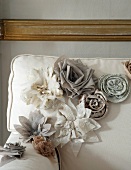 Decorative flowers draped on a sofa backrest