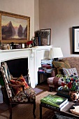 Antique upholstered chair in a living room in front of a classic fireplace and an Impressionist painting