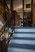 Staircase in villa with antique chair on landing