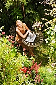 Woman working on laptop in garden