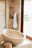 Free-standing, stone bathtub