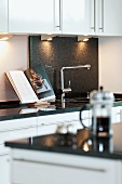 Kitchen counter with sink and open cookery book