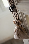 Lavender bag hanging from key in door lock