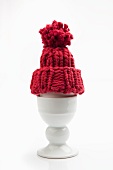 Eggcup with egg and egg cosy