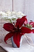 Arrangement of red lilies and wild carrot