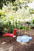 Home-made swings in the shape of an aeroplane and flower